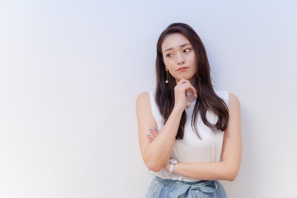 あごに手を当て何かを考える女性