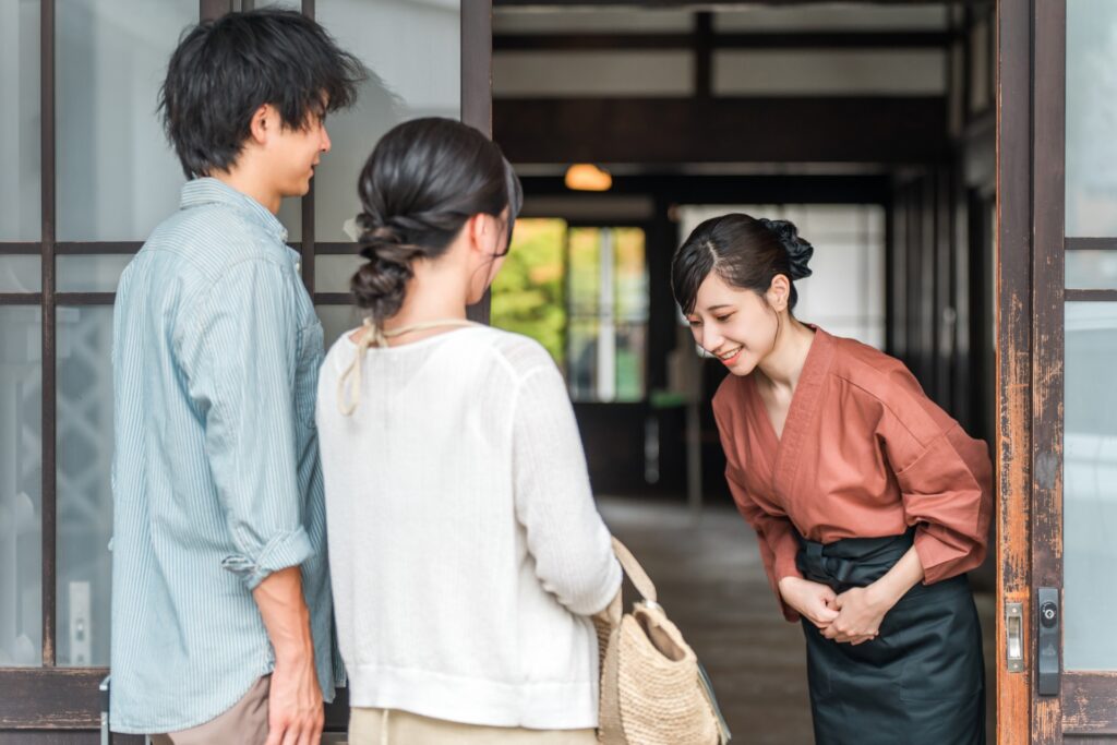 宿泊客と出迎えるスタッフ
